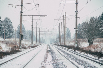 Winter Russian Railway. Public transport. winter road. Rails and sleepers. Electricity