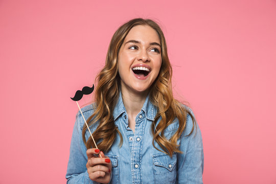 Laughing woman wearing in denim shirt posing with fake mustache