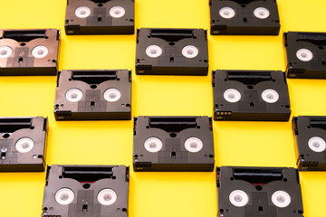 Vintage mini DV cassette tapes used for filming back in a day. Pattern made of plastic video tapes...
