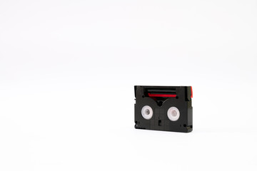 Vintage mini DV cassette tape used for recording video back in a day. Plastic, magnetic, analog film tape on white background