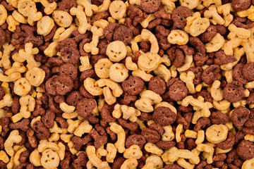  Chocolate flakes in the form of skulls and bones background. Top view.