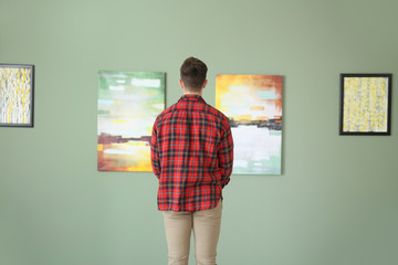 Man at exhibition in modern art gallery