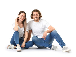 Fototapeta na wymiar Stylish young couple in jeans on white background