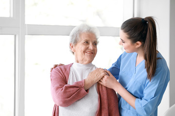 Medical worker with senior woman in nursing home