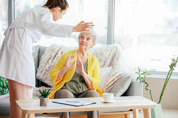 Doctor mistreating senior woman in nursing home
