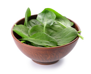 Bowl with fresh spinach on white background