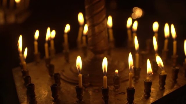 candles are lit on the candlestick in the church