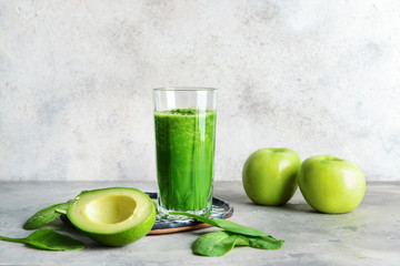 Glass of fresh smoothie on grey table