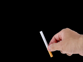 Hand holding the cigarette on the black background with the clipping path