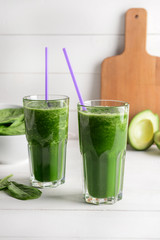 Glasses of fresh smoothie on white table