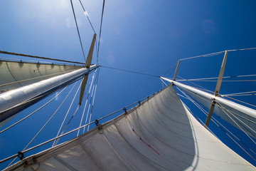 Mast of sailing yacht against the blue sky at sunny day