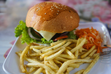 Burger and french fries on the table. Delicious food fast food. American food in a cafe
