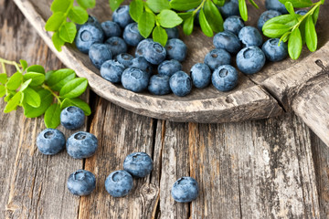 Blueberries with leaves on  old wooden table