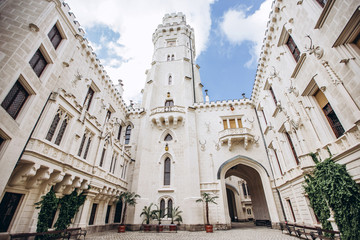 Fototapeta premium Hluboka nad Vltavou, Czech Republic, MAY 4, 2018 - the ensemble of the white castle Hluboka nad Vltavou and the park in sunny weather. The architectural ensemble in the Czech Republic.