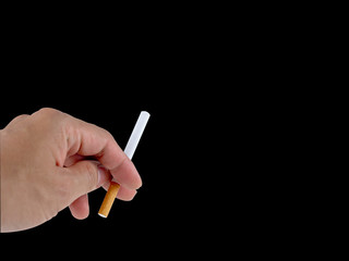 Hand holding the cigarette on the black background with the clipping path