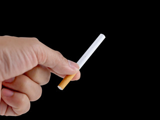 Hand holding the cigarette on the black background with the clipping path