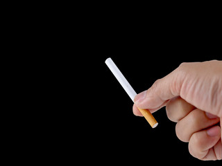 Hand holding the cigarette on the black background with the clipping path