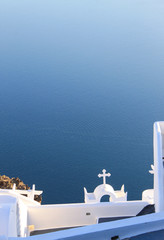 Santorini caldera view church and bright clear sea water surface. Cycladic landscape.