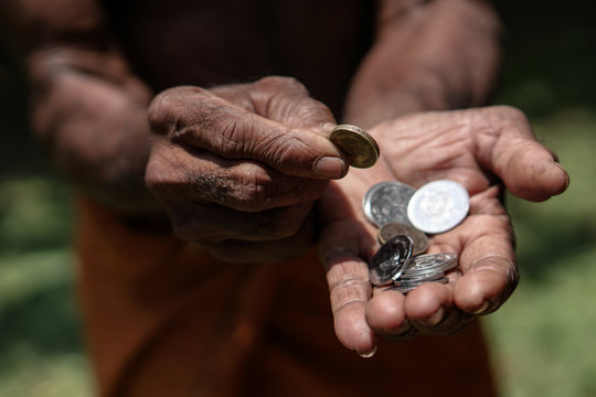 Coins In Dark Working Hands. Beyond The Poverty Line In Asian Countries. Subject Soap Bar.