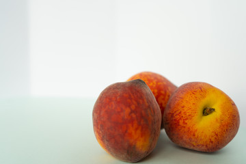ripe peaches on white background
