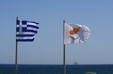 National flags in front of sea and sky