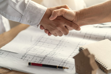 Customers handshake agreement with the contractor for construction of houses
