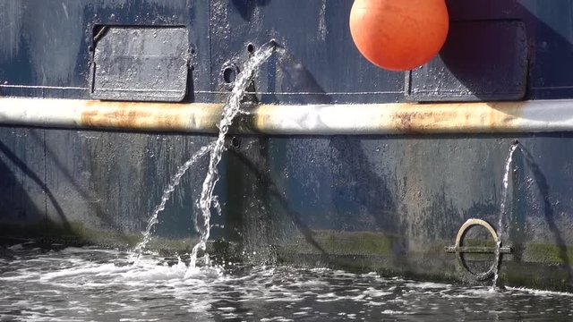 Jets of water from marine engine cooling system.