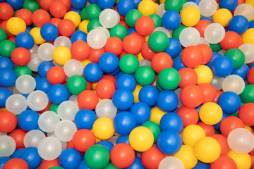 Fototapeta na wymiar Balls for a dry pool background. Background of many colored plastic balls. Baby Delight Bright colored balls. Plastic balls
