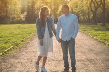 A young couple spends time together outdoors. Couple having fun summer time