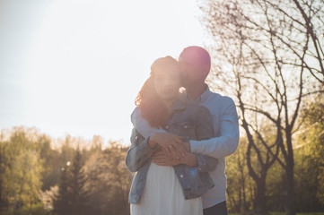 A young couple spends time together outdoors. Couple having fun summer time