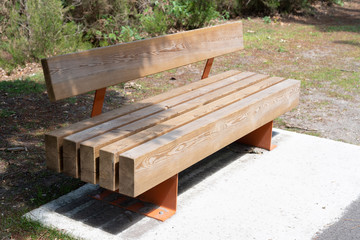 Modern brown empty bench at city park