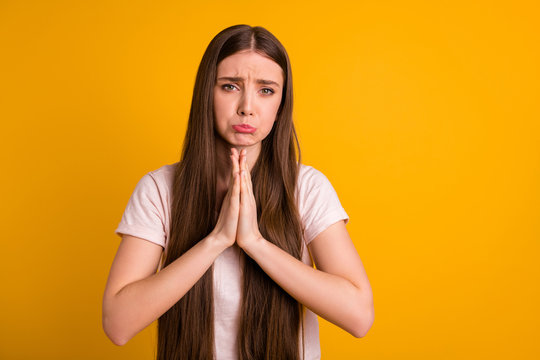 Portrait of disappointed lady youth have palm together religion anticipation bad mood please plead sorry appologize isolated yellow background dressed fashionable clothing  