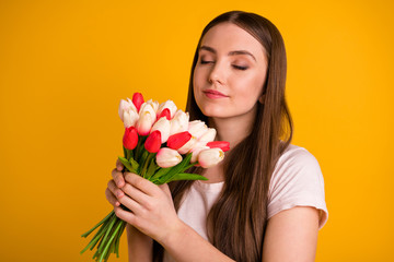 Obraz na płótnie Canvas Close up photo beautiful amazing her she lady very long hairstyle hands smell fresh flowers white red tulips surprise birthday party eyes closed wear casual t-shirt isolated bright yellow background