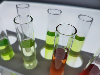 Multiple test tubes packed with chemicals, close-ups, background