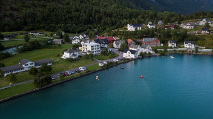 Fototapeta na wymiar Aerial view of Hjelle, a village in the Oppstryn municipality, in Norway, on the shore of Oppstrynsvatnet lake