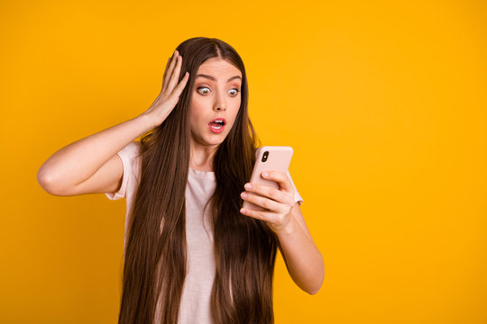 Close up photo beautiful amazing she her lady very long hairstyle hold hands arms telephone got letter email boss chief fired work oh no wear casual pastel t-shirt isolated yellow bright background