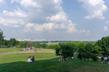 Naklejka premium people on meadow with view on Moscow