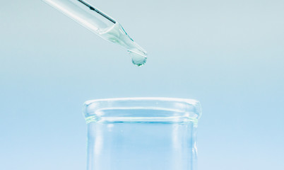 Pipettes take samples to a test tube containing chemicals.