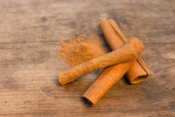 cinnamon sticks on the wooden table and cinnamon powder
