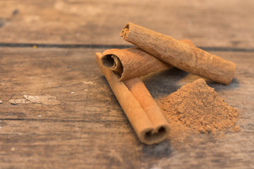 cinnamon sticks on the wooden table and cinnamon powder