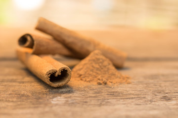 cinnamon sticks on the wooden table and cinnamon powder
