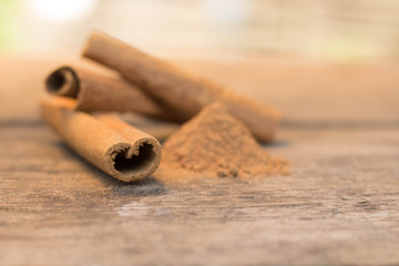 cinnamon sticks on the wooden table and cinnamon powder