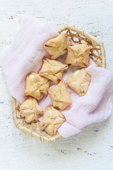 sweet pastry envelopes with cottage cheese in a wicker basket on a white background