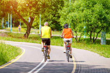 Naklejka premium Cyclists ride on the bike path in the city Park 