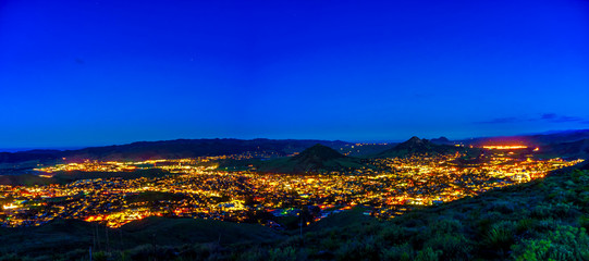 Fototapeta na wymiar View of City at Night with Mountains