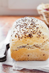 Homemade wheat bread with flax seeds on a kitchen table