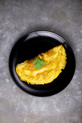 Omelette with tomatoes slide, coriander and scallion.