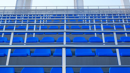 Obraz premium Blue plastic seats. Free arena seating. Empty plastic chairs seats for football fans.