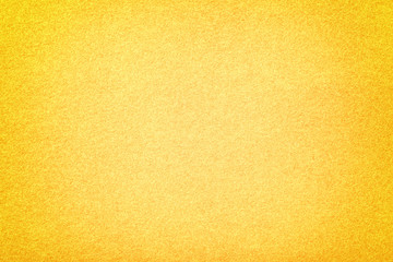 Light yellow matt suede fabric closeup. Velvet texture of felt.