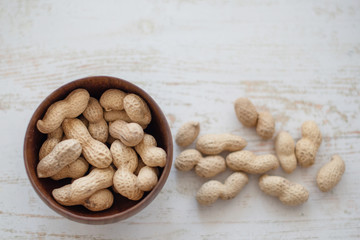 peanuts in the shell in a wooden bowl
